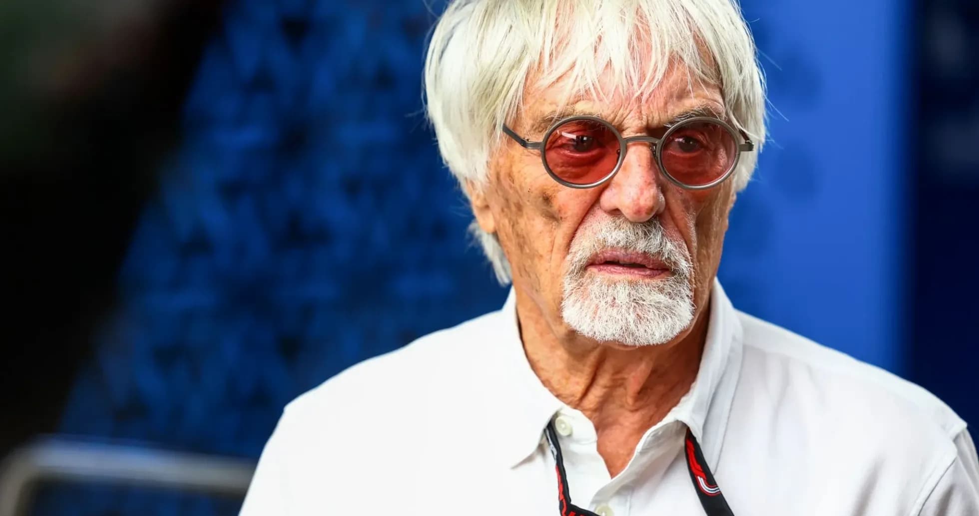 Man with white hair and sunglasses at event