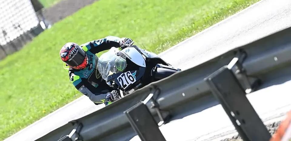 Rider leaning into a curve on motorcycle track