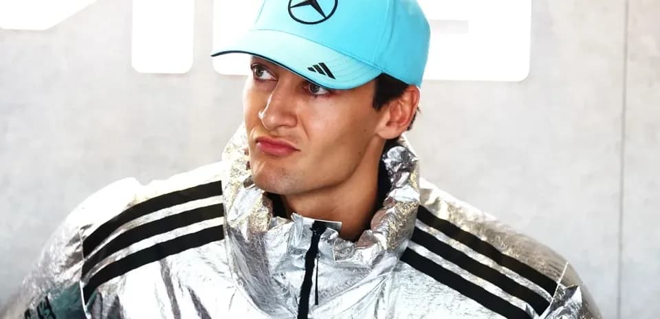 Formula 1 driver in silver jacket and cap