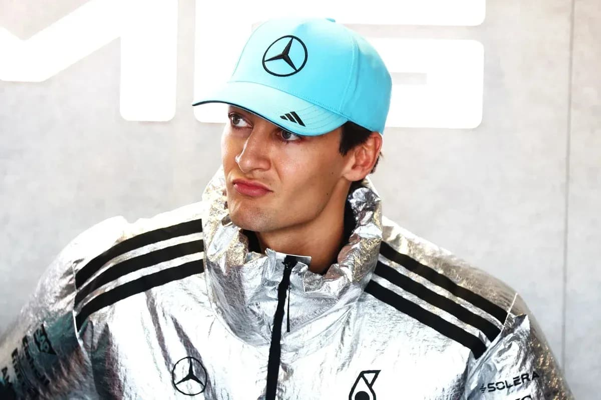 Formula 1 driver in silver jacket and cap