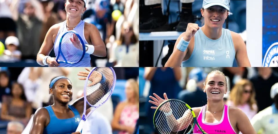 Four female tennis players celebrating on court