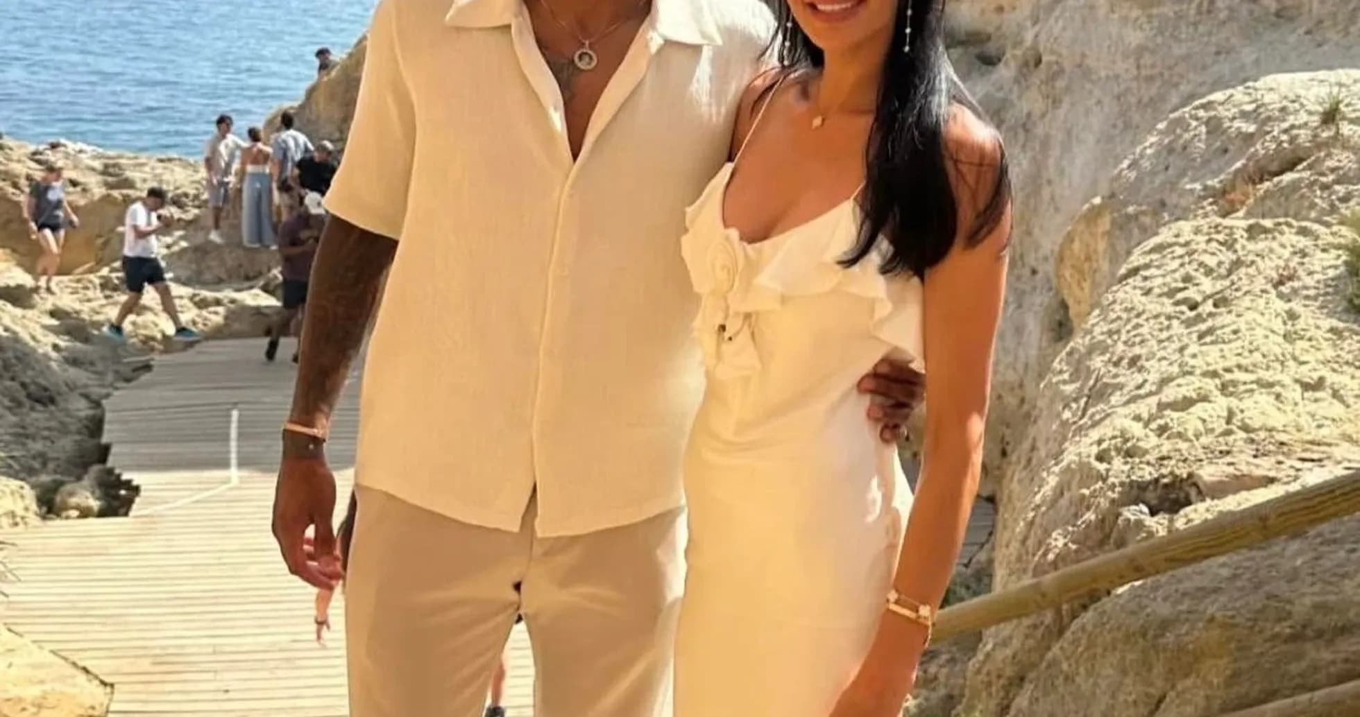 Juventus player and companion posing by the sea