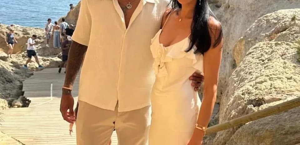 Juventus player and companion posing by the sea