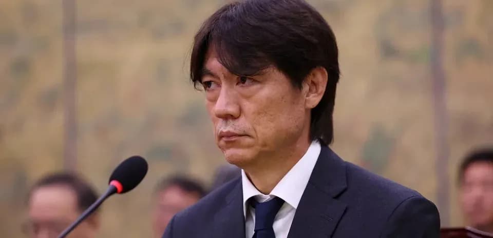 Man in suit at a formal event speaking