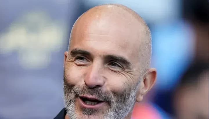 Bald man with a beard smiling during event