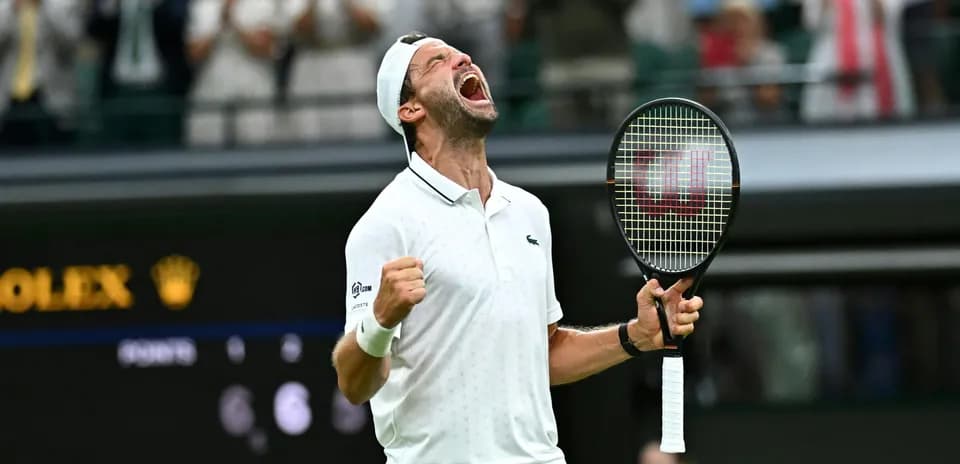 Tennis player celebrating victory at Wimbledon match