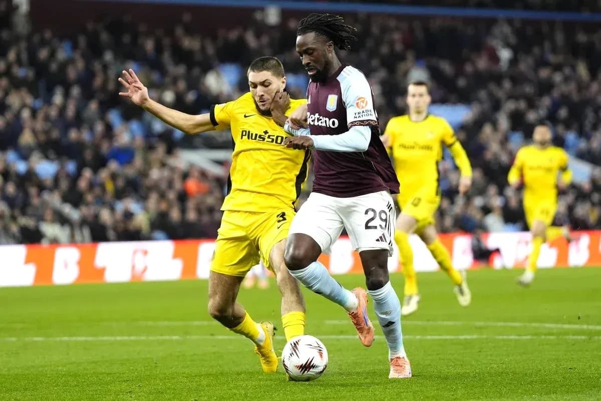 Aston Villa player dribbling past opponent during match