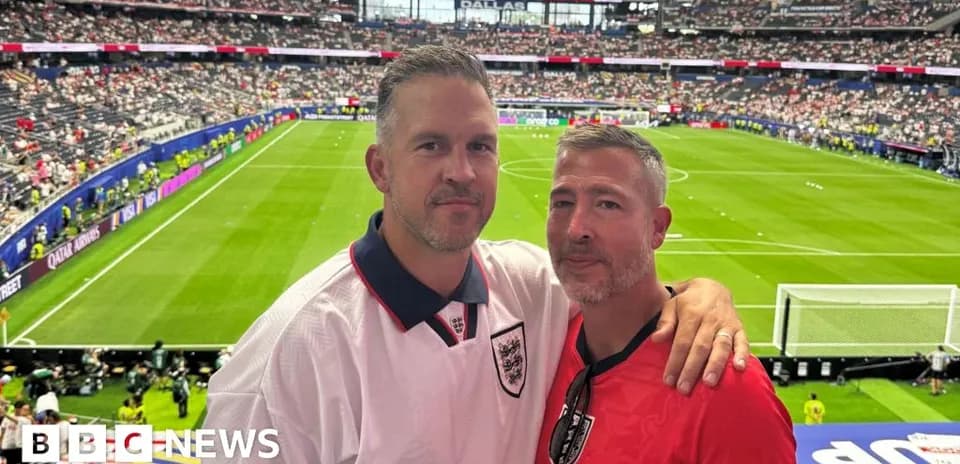 Two fans posing in stadium before match