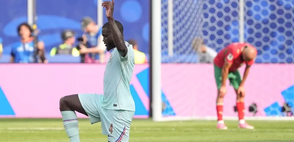 Player kneeling on pitch during match action