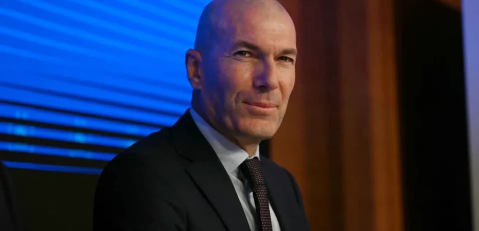 Bald man in a suit at a press conference