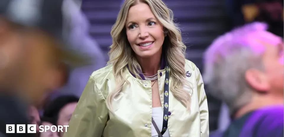 Woman in a gold jacket at a basketball game