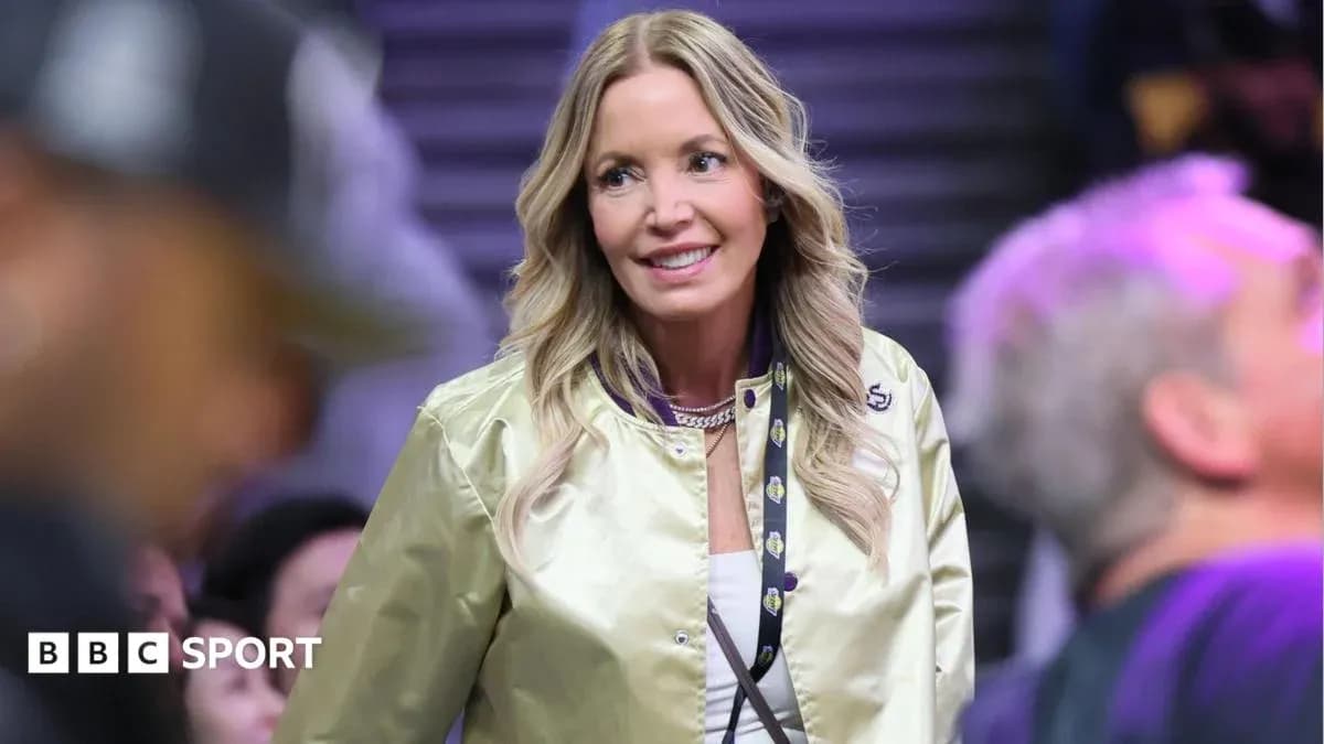 Woman in a gold jacket at a basketball game