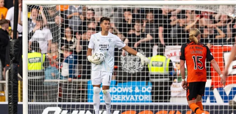 Goalkeeper gesturing during match with players nearby