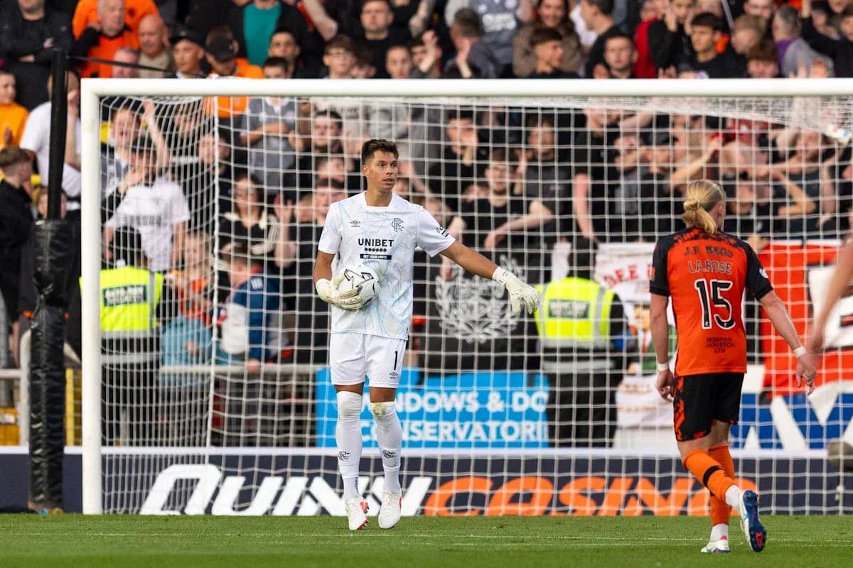 Goalkeeper gesturing during match with players nearby