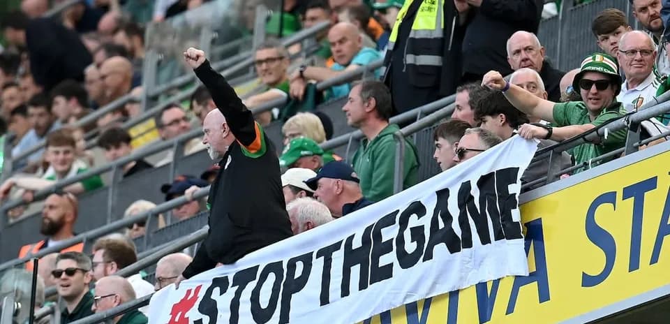 Fans holding banner during sporting event in stadium