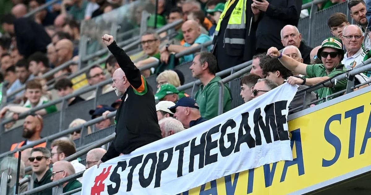 Fans holding banner during sporting event in stadium