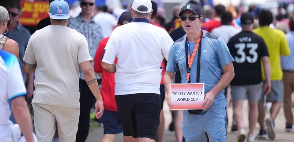 Fan holding sign asking for World Cup tickets