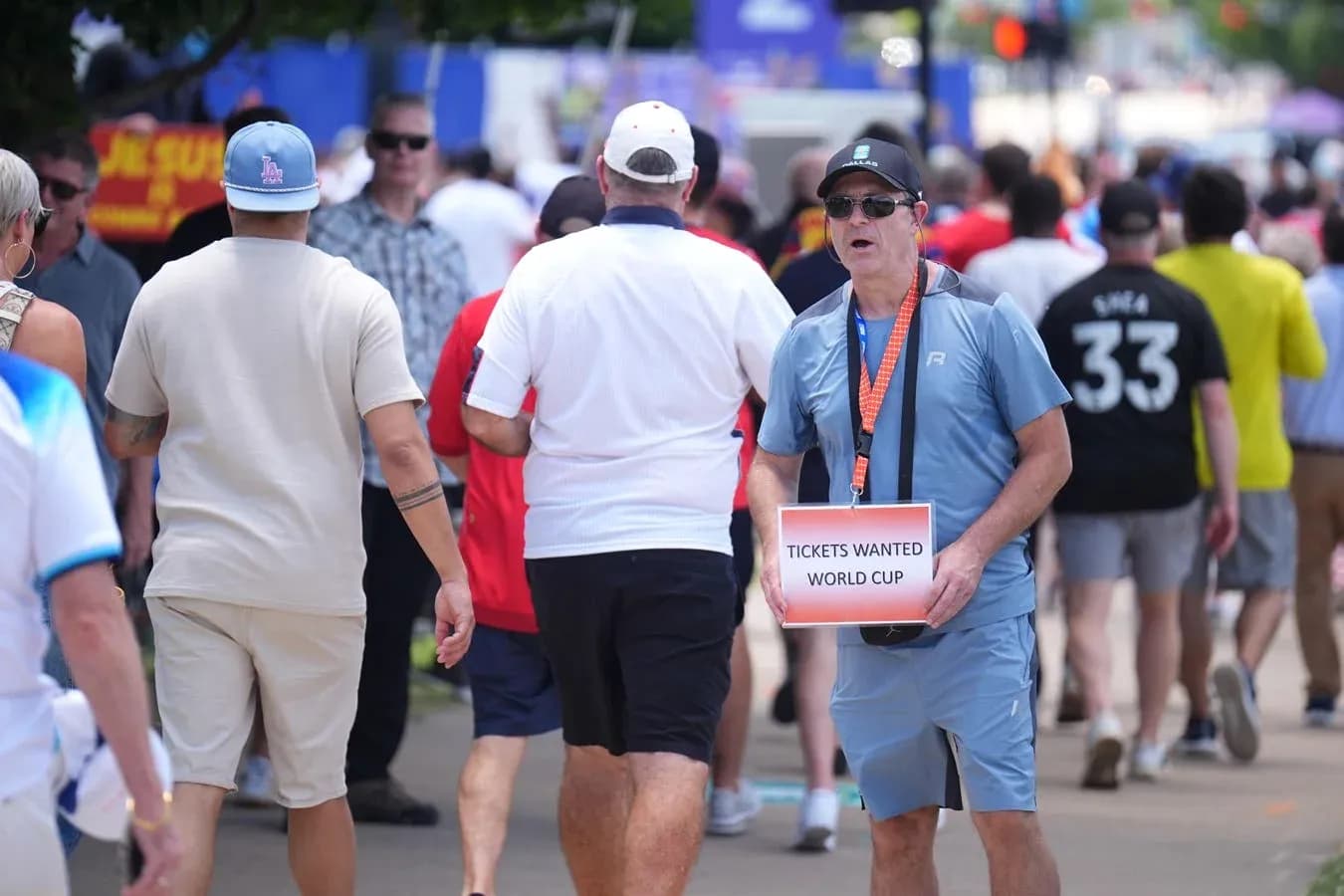 Fan holding sign asking for World Cup tickets
