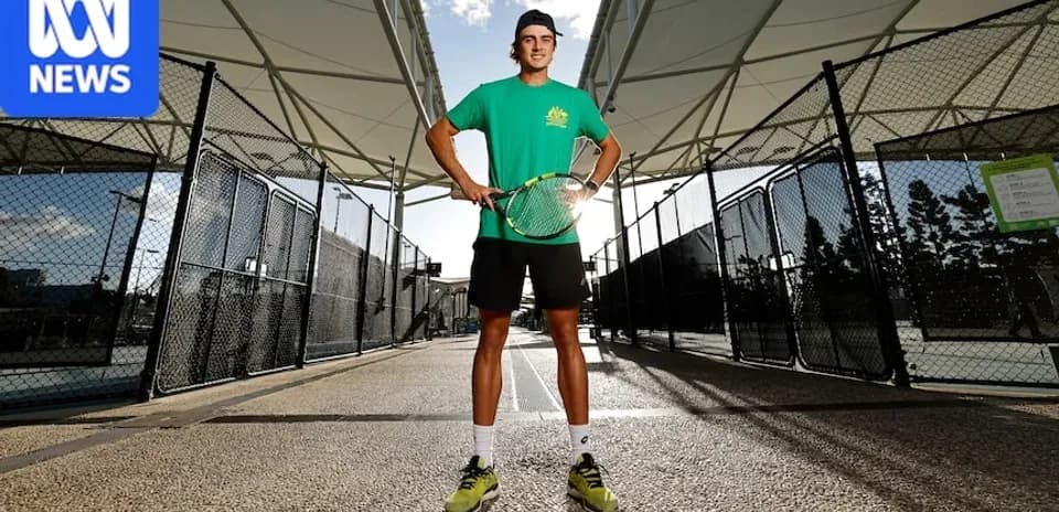 Tennis player posing with racket on court