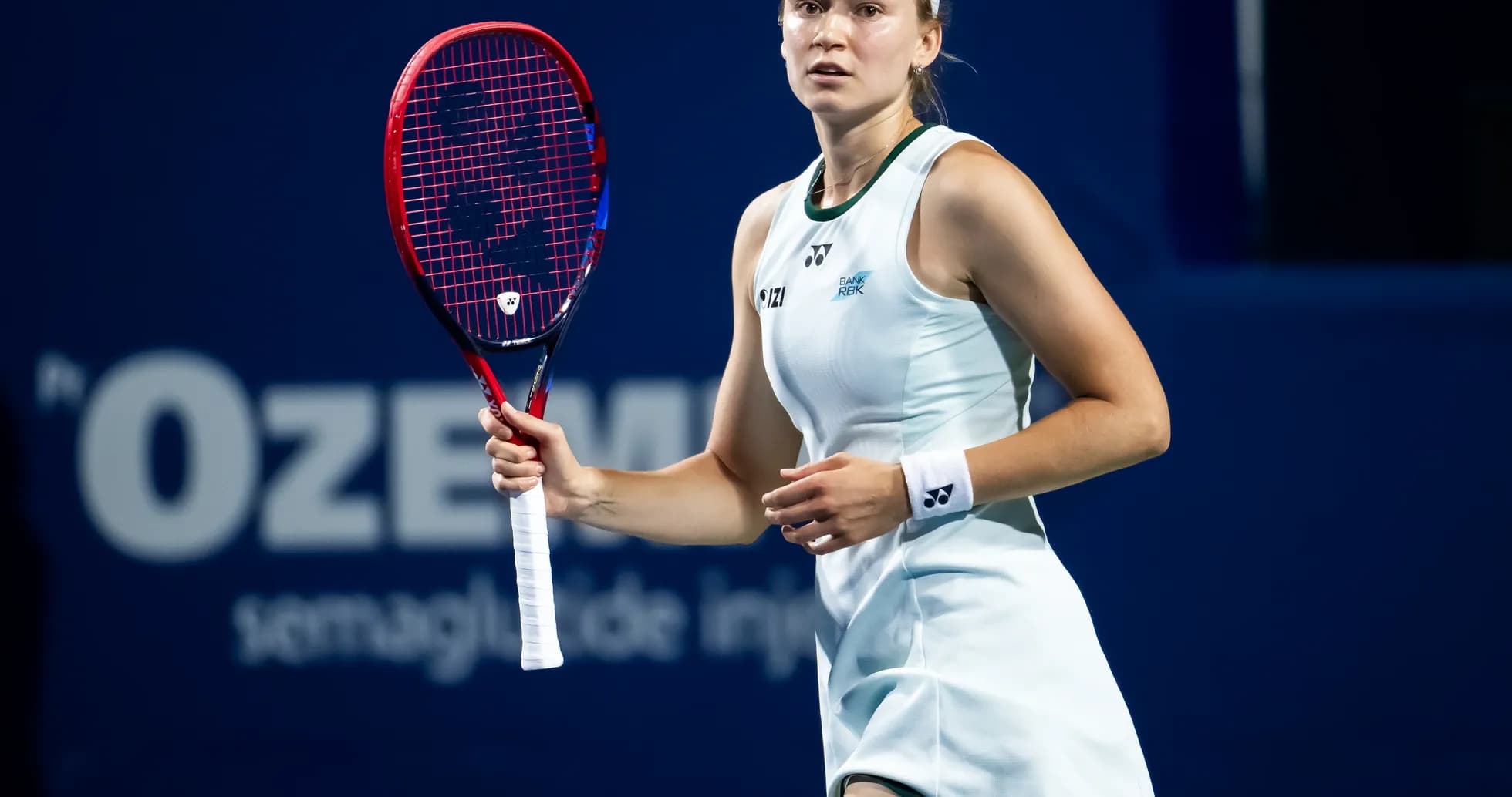 Tennis player preparing to serve with racket