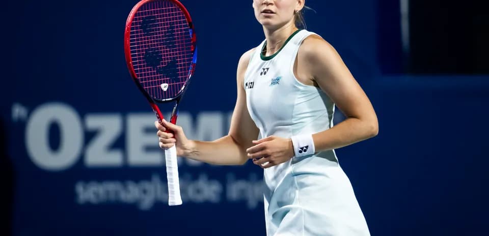 Tennis player preparing to serve with racket