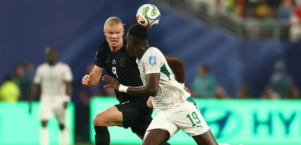 Two players competing for the ball during match