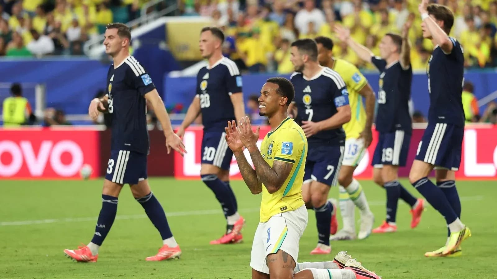 Brazilian player kneeling on field during match