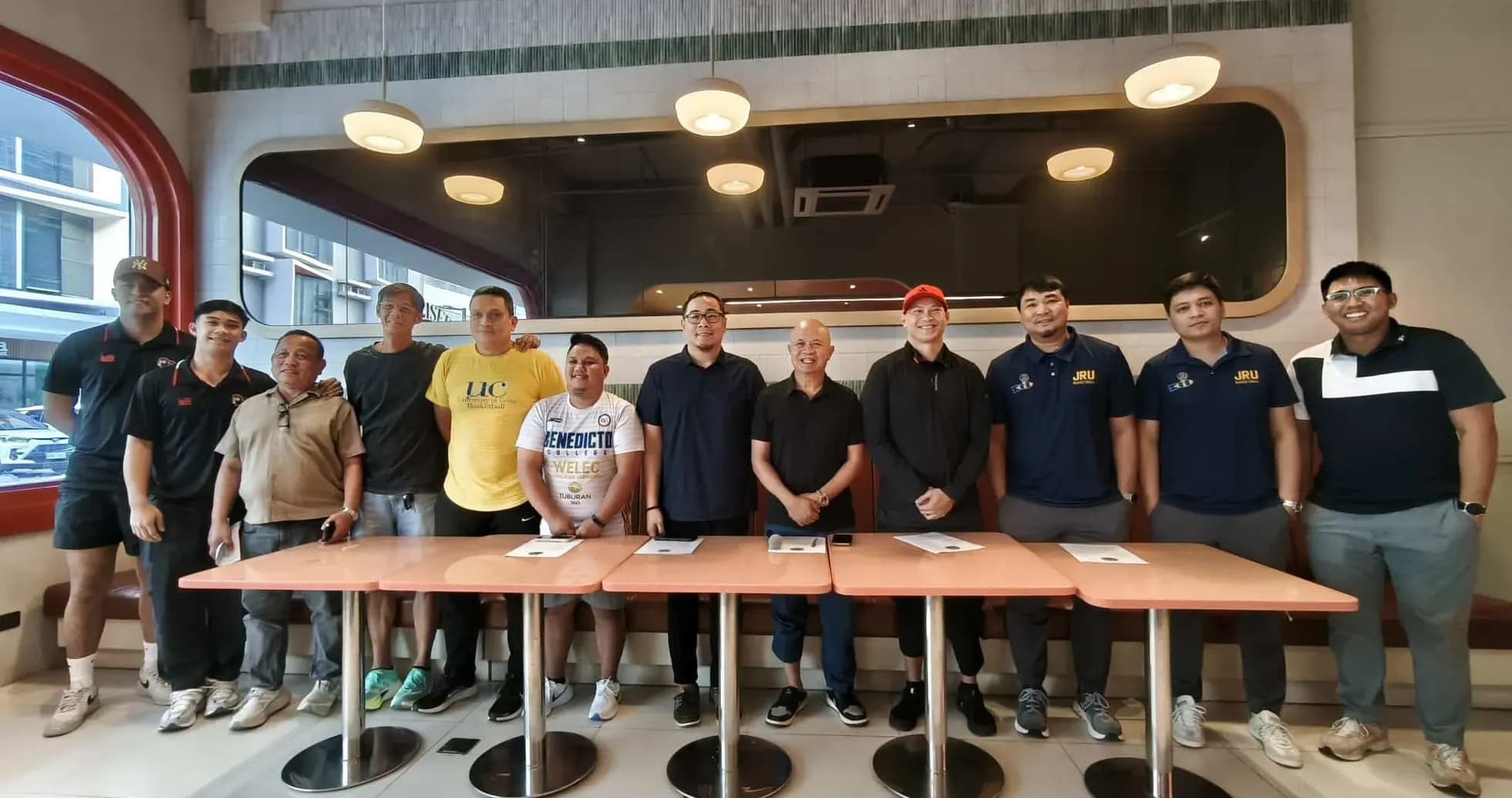 Group of individuals posing together in a restaurant
