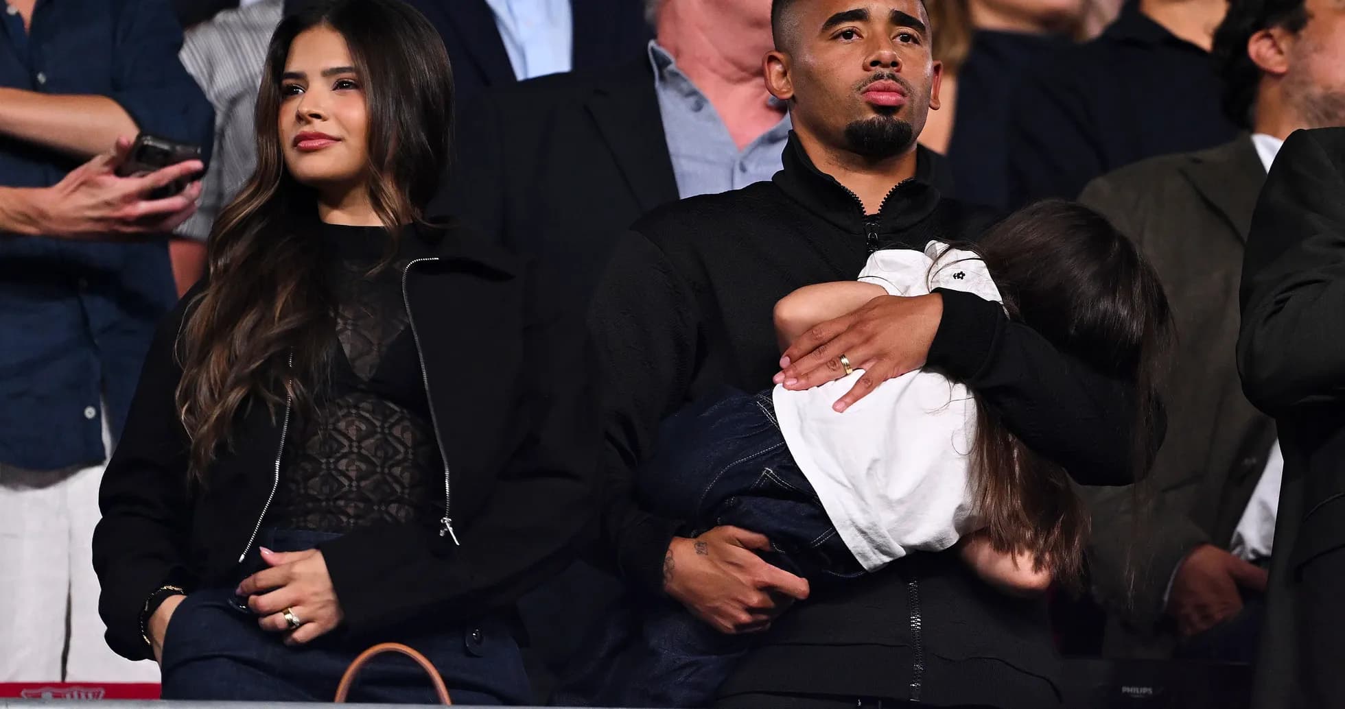 Couple with child at an event in the stands