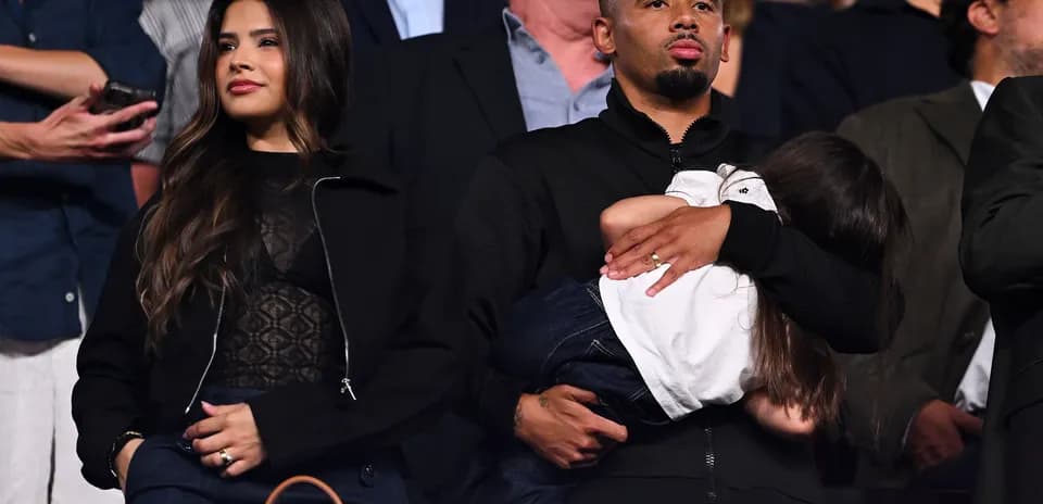 Couple with child at an event in the stands