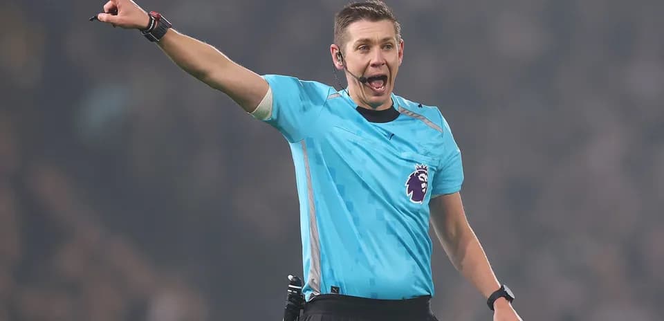 Referee signaling during a Premier League match