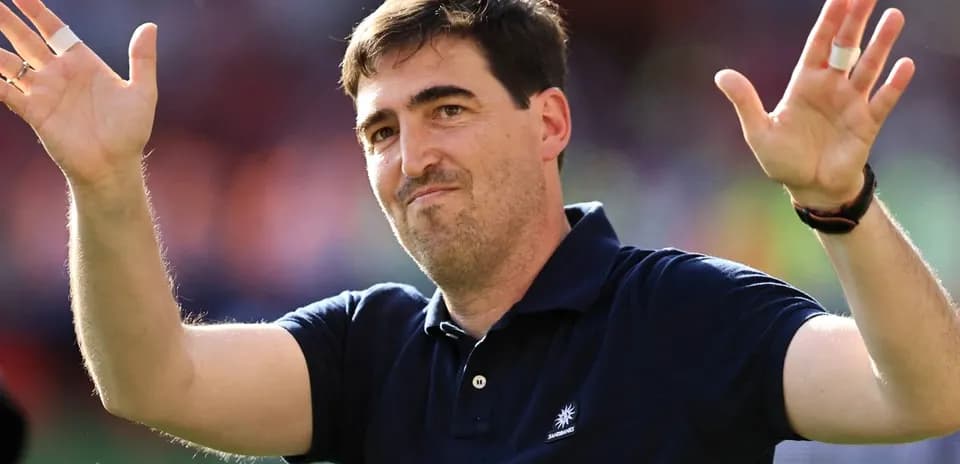 Person waving hands at a sports event