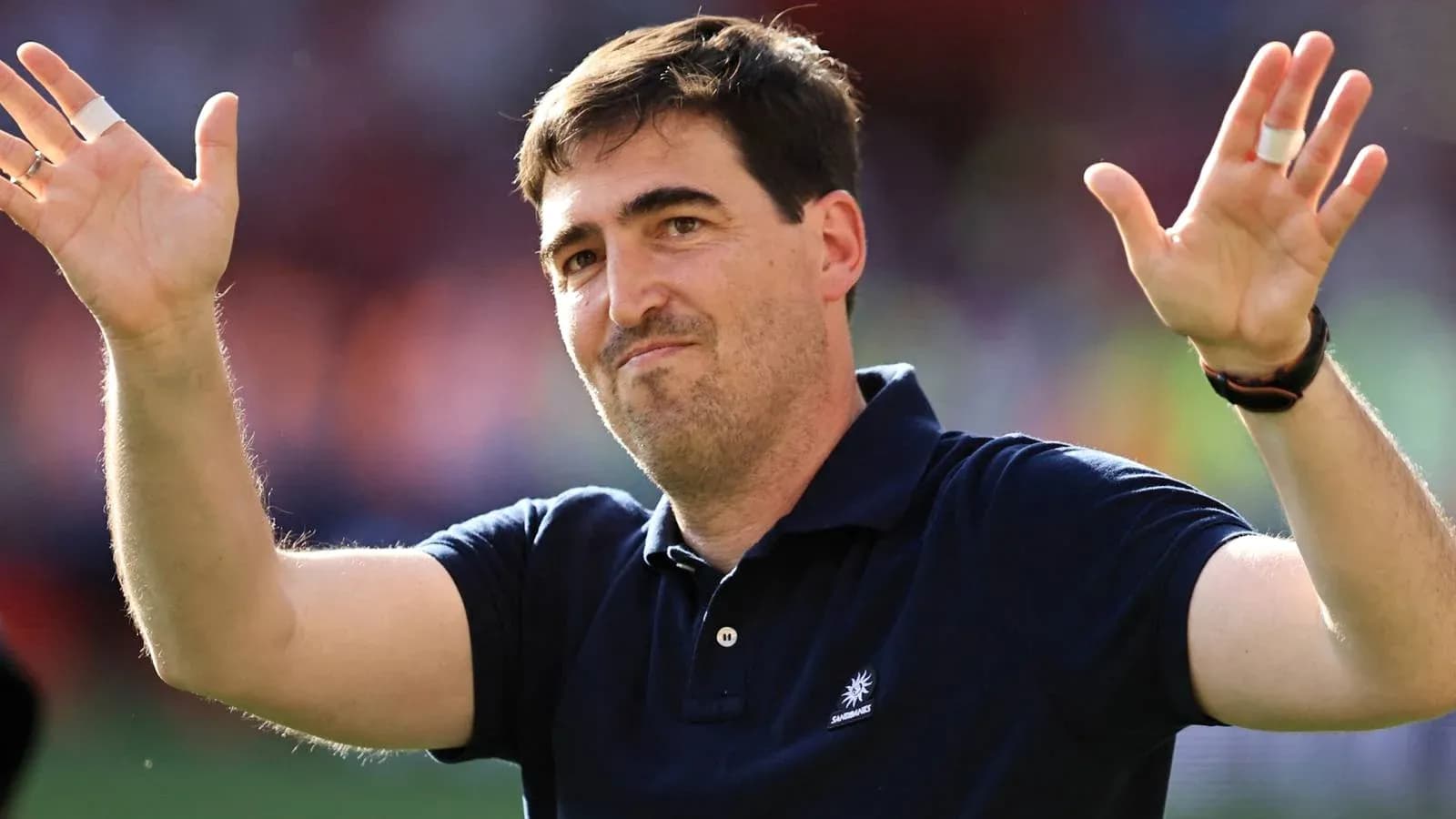Person waving hands at a sports event