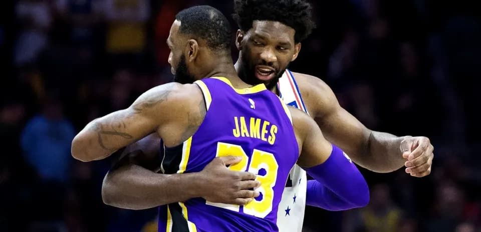 LeBron James and Joel Embiid embracing on court