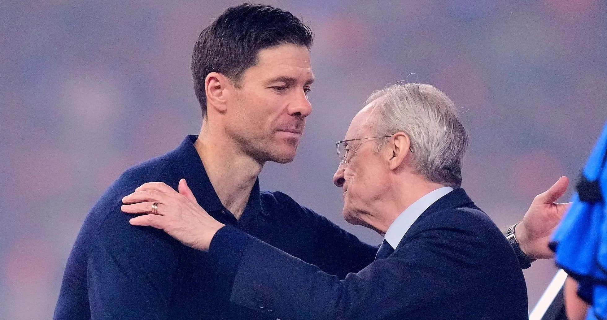 Two men embracing on a football field