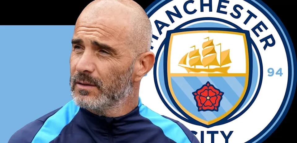 Coach near Manchester City logo during press event