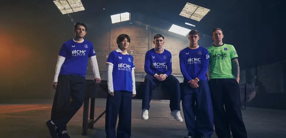 Everton players in new kit posing indoors
