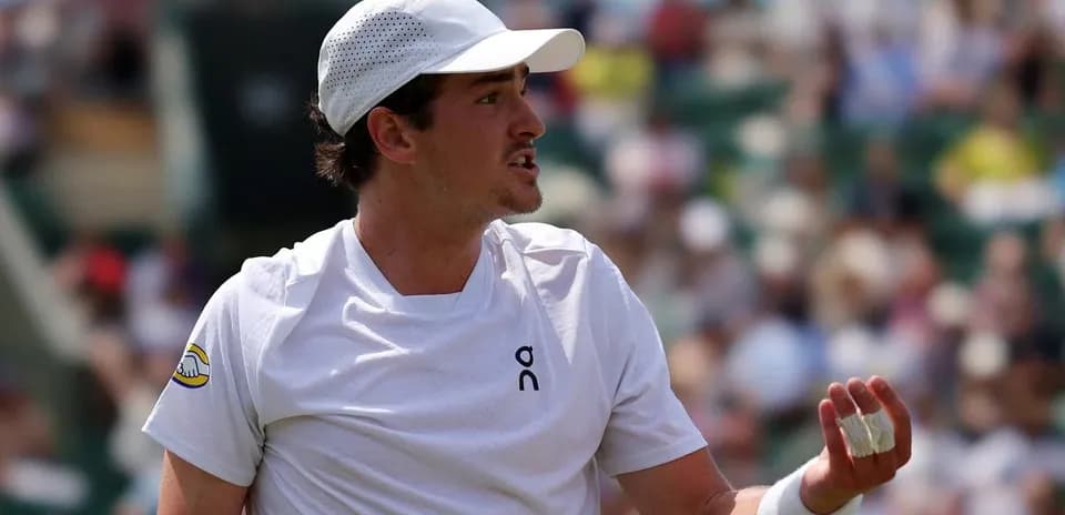 Tennis player gesturing during a match