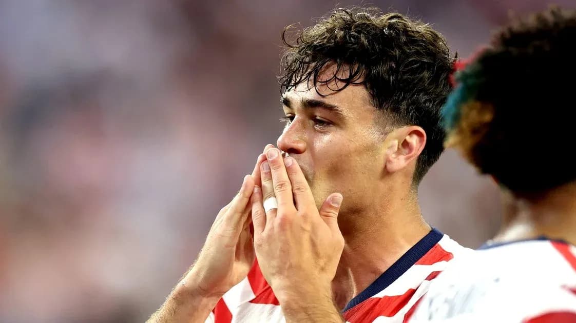 Futbolchi jamoaga qo'shilish uchun qo'llarini ko'tarayapti