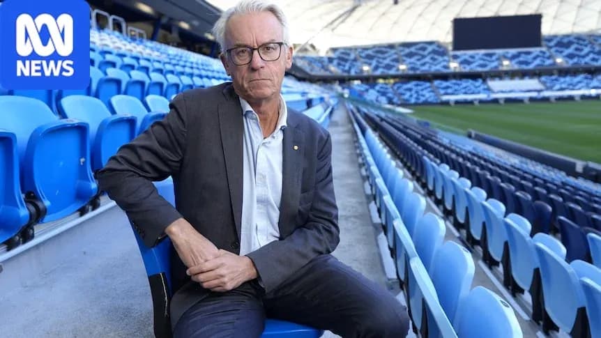 Man seated in empty stadium seats