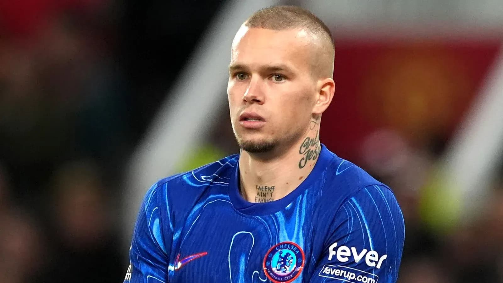 Futbolchi Chelsea formasida, maydonda turibdi
