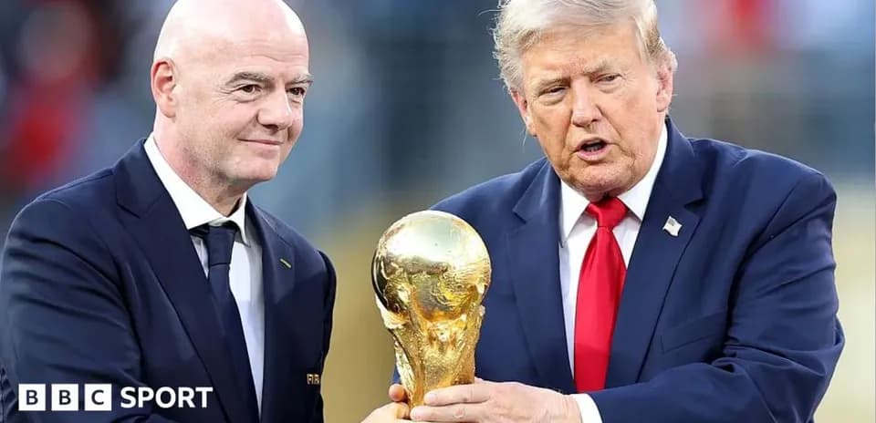 FIFA president and official holding World Cup trophy