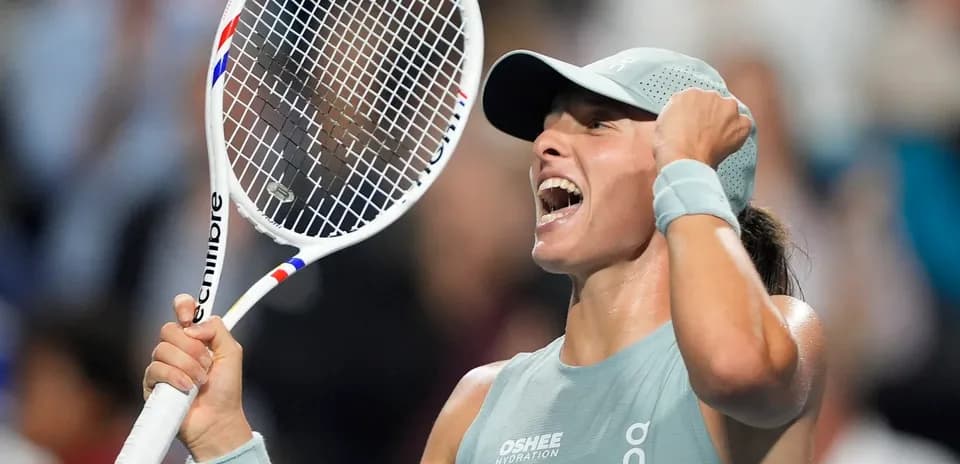 Tennis player celebrating with racket in hand