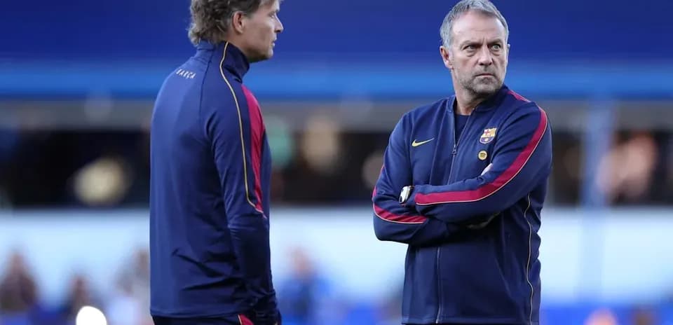 Two coaches discussing strategies on the pitch