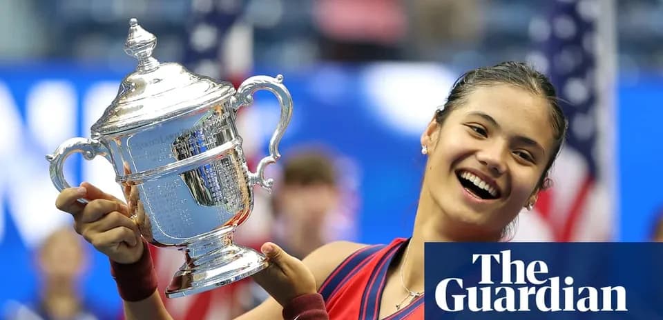 Tennis player holding US Open trophy on court