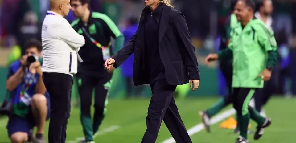 Coach walking on the field during match