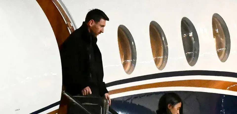 Lionel Messi exiting private jet with companion