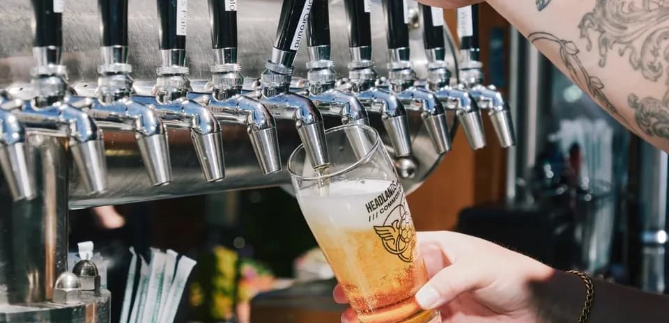 Pint being poured from a beer tap