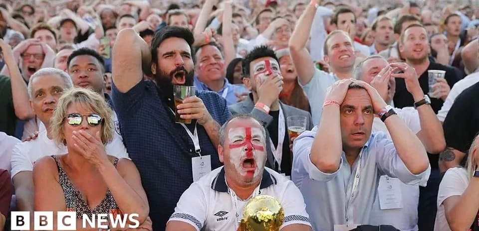 Football fans reacting during a live match viewing
