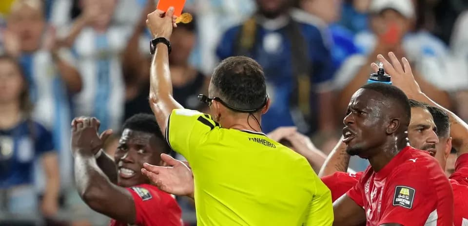 Referee showing red card during heated match situation